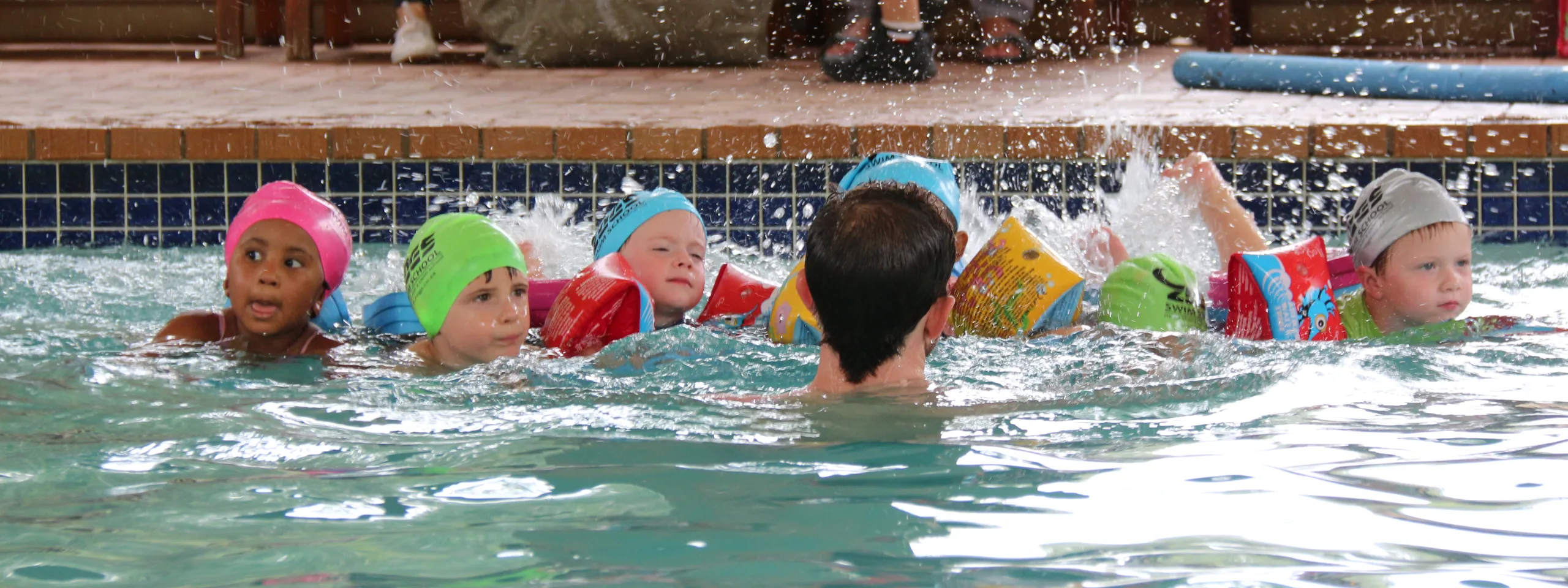 Kids enjoying indoor swimming lessons at Zogs Swim School during winter.